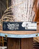 Perfume displayed on wooden table.