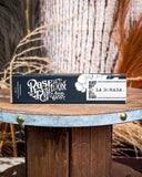 Perfume displayed on wooden table.