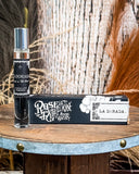 Perfume displayed on wooden table.