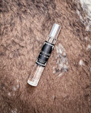 Perfume displayed on cowhide.