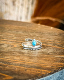 Ring displayed on wooden table.