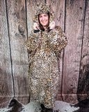 Person wearing a leopard print blanket hoodie against a wooden background