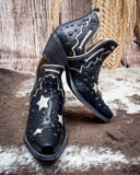 Black cowboy boots with star and star-in-circle designs on a textured surface