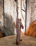 Brown leather bag with decorative elements on a wooden surface