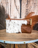 Wallet with cowhide pattern on a wooden surface