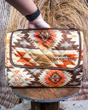 Patterned picnic blanket on a wooden stand with a rustic background
