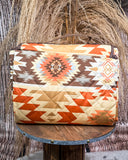 Patterned picnic blanket on a wooden stand with a rustic background