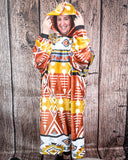 Person wearing a colorful patterned hooded blanket against a wooden background