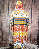 Hooded blanket with geometric pattern against a wooden background