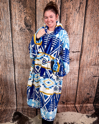 Person wearing a blue and white patterned hoodie against a wooden background