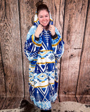 Person wearing a blue and white patterned blanket hoodie against a wooden background