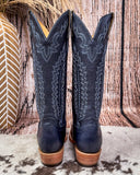  Tall Western boots on Cowhide rug with Boot stich design back of the boots tan heels 
