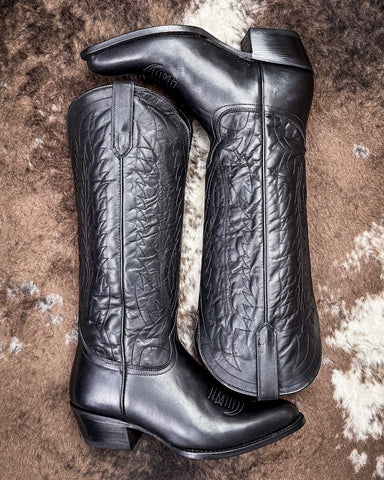 Black Leather boots on cowhide rug 