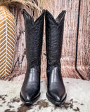 Black Leather boots on cowhide rug  white boot stich design 
