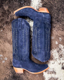 Pair of blue cowboy boots with white stitching on a textured surface