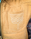 Close-up of a brown vest with a white boot stitch design on the pocket.