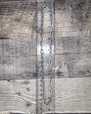 Metal chain on a wooden surface with a ruler for scale