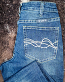 Blue jeans with a brand logo on the back pocket against a textured brown background