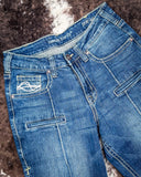 Blue jeans with visible branding on a textured surface