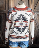 Lean On Me Knit Sweater displayed and styled on mannequin in front of wood background.
