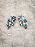 Checkerboard lightning bolt earrings with turquoise colored stones.