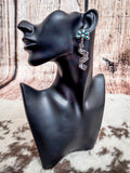 Aqua flower and silver spiral earring displayed on mannequin.