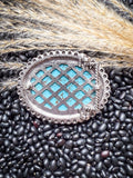 Back view of Western belt buckle and metal clasp against rustic natural background