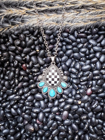 Rustic turquoise and silver pendant necklace with checkerboard detail on black beans and pampas