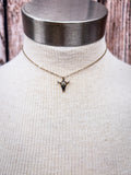 Steer head necklace displayed on a mannequin 
