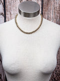 Gold toned western beaded displayed on a mannequin 