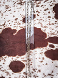 Chain necklace displayed on a ruler