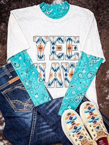 Western 'Yee Haw' graphic tee layered with turquoise paisley base layer, jeans and Aztec sneakers