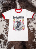 Laid flat Rodeo Vibes vintage ringer t-shirt with cowboy bull riding and sunflower print
