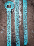 Turquoise floral western belt laid flat showing full tooled leather design.