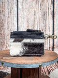 Back view of cowhide wallet with black leather zipper pocket and brass clasp keychain.