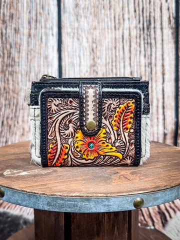 Tooled leather cowhide wallet with vibrant floral design and turquoise accent snap.