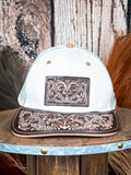 Western-style snapback cap with floral tooled leather brim and front patch