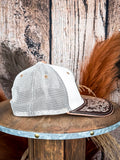 White and tan mesh trucker hat with floral tooled leather bill