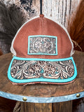 Front view of brown trucker hat with turquoise western tooled leather detail