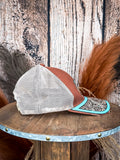 Side view of brown mesh trucker hat with turquoise floral tooled leather bill