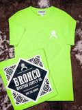 Flat lay of Havasu Tee in neon green with southwestern diamond print and bold Bronco logo.