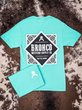 Back of bright teal Bronco tee with bold western-style logo and folded front detail