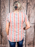 Back view of woman wearing peach and navy vertical stripe top, showing puff sleeve detail.