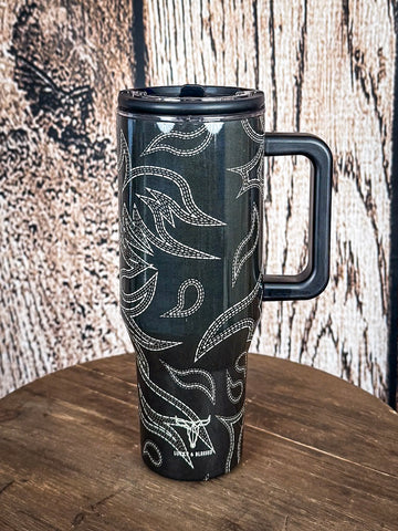Handled tumbler with flame stitch design.

