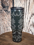 Tall tumbler with stitched western pattern.