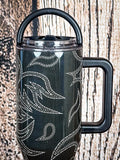 Western tumbler with loop handle on lid.

