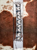 Silver colored Apple Watch band with raised heart design measured on clear ruler