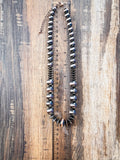 Chunky faux Navajo pearl necklace with oxidized and copper-tone beads shown with ruler for scale.