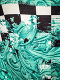 Close up of fabric with checkered print and turquoise tooled leather pattern 