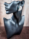 Mannequin wearing a stud earring